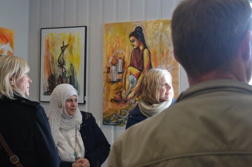 Kayed (i midten) forteller nysgjerrige kunstgjengere om historiene bak bildene (FOTO: H. Edvardsen)